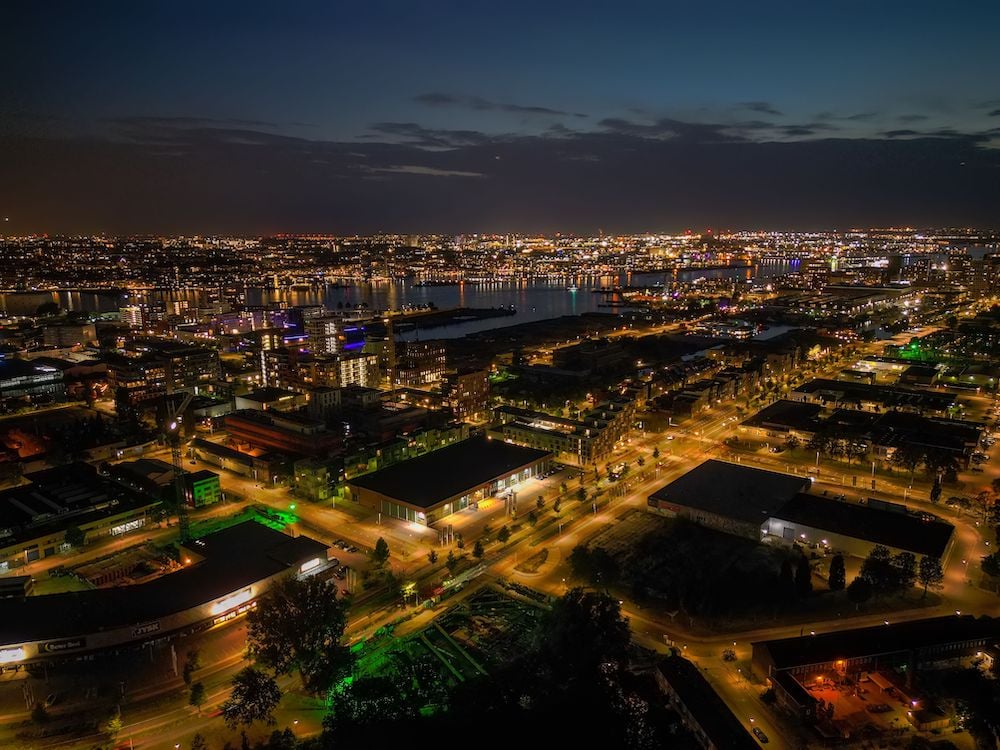 drone-shot-of-an-illuminated-cityscape-with-highwa-2023-01-05-02-30-56-utc-1